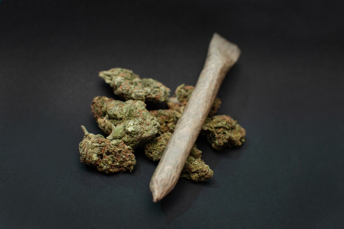 close up of marijuana buds and a joint on a black 2023 11 27 05 25 24 utc